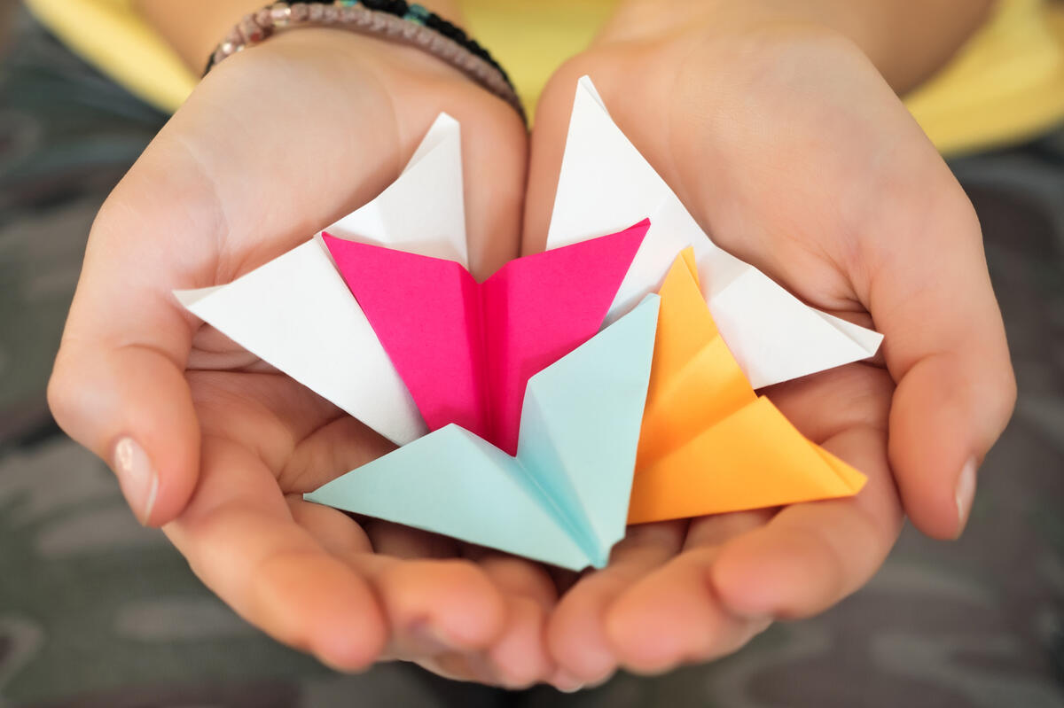 Hands holding paper airplanes Hands holding paper airplanes